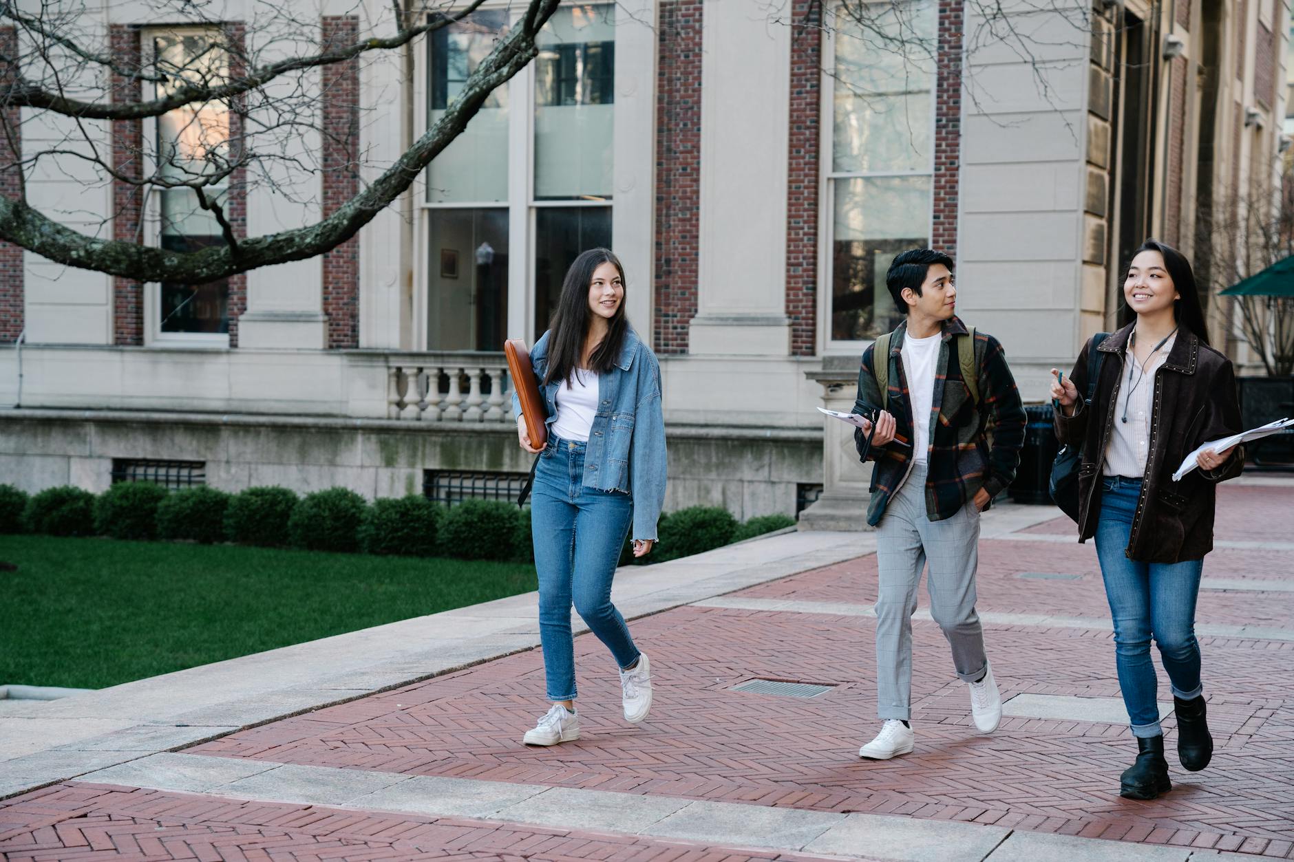 Students walking across a college campus on a recruiting visit